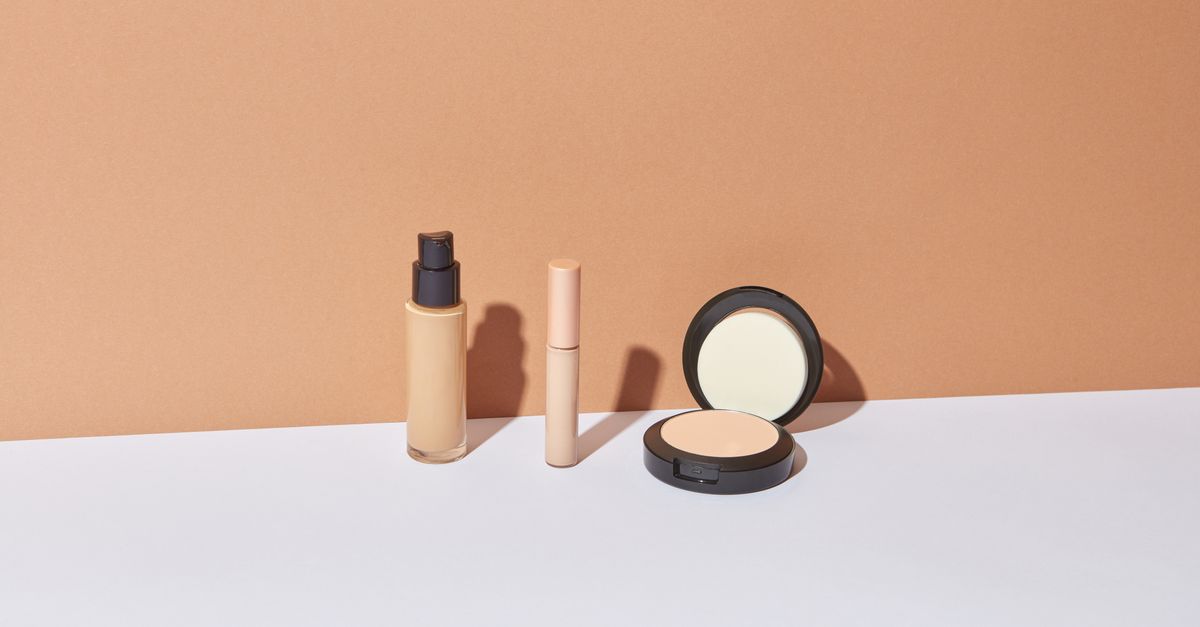 Three cosmetic products lined up against a tan background