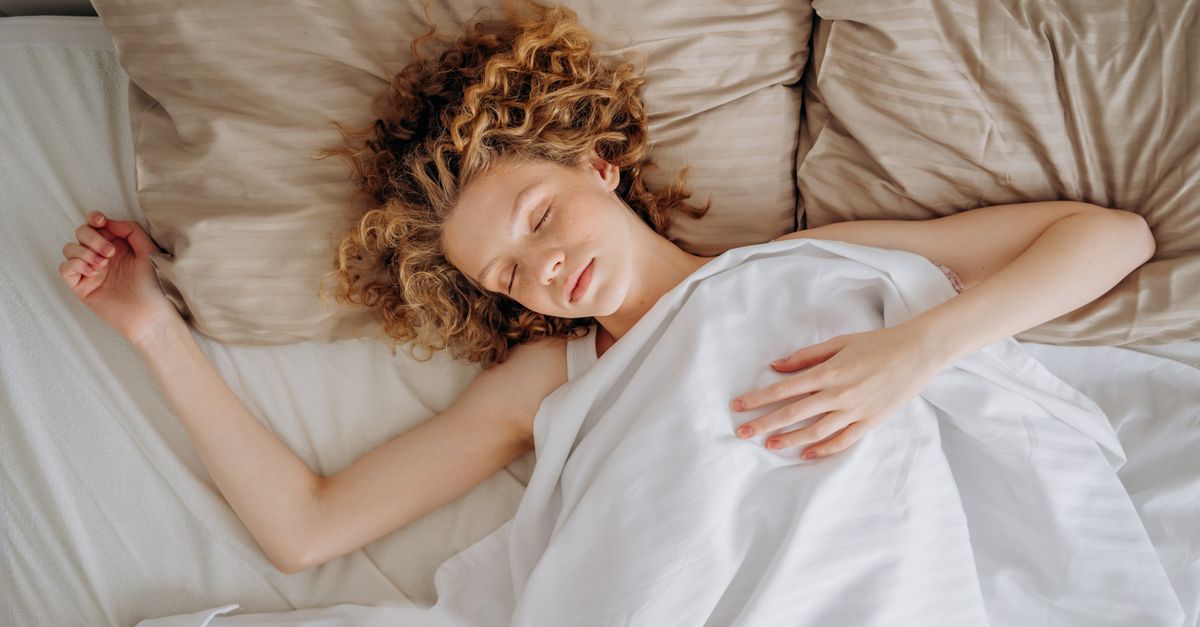 Woman sleeping on white sheets